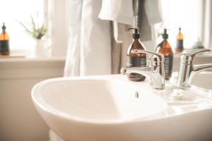 a bathroom with a sink and a mirror and a sink at Cedar House in Gisborne