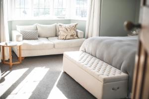 a living room with a couch and a bed at Cedar House in Gisborne