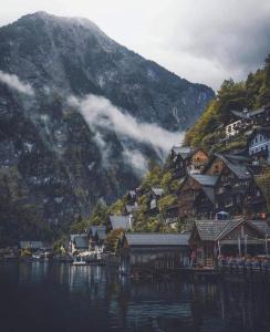 a village on the side of a mountain in the water at Apartment Diana in Bad Goisern