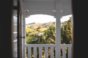 a window with a view of a mountain view at Cedar House in Gisborne