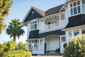a house with a black and white at Cedar House in Gisborne