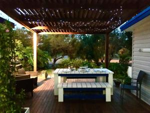 a picnic table on a patio with a pergola at SHELLHARBOUR BEACH COTTAGE ---- Back gate onto Beach, Front gate walk to Marina in Shellharbour