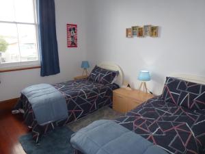 a bedroom with two beds and a window at Old world charm in town and by the sea in Napier