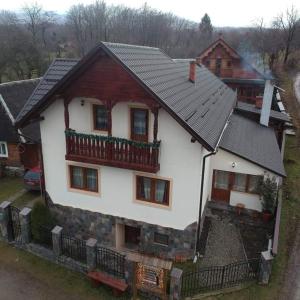 a large white house with a black roof at Pensiunea Viorica in Breb