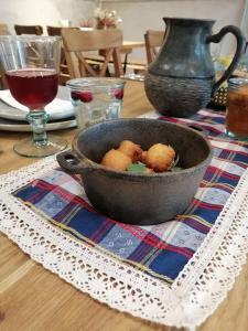 a bowl of food sitting on a table at Zyplių Dvaro Oficina Viešbutis 