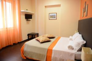 a hotel room with a bed and a window at Civico7 in Villa San Giovanni