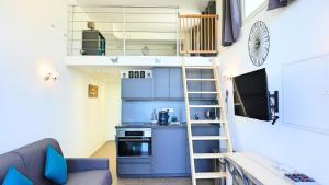 a tiny apartment with a loft bed and a kitchen at Appartement 174, Vue mer à Cap Esterel By Palmazur in Saint-Raphaël