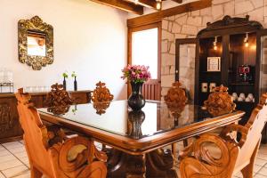 a dining room with a glass table and chairs at Casa Mayo B&B in Oaxaca City