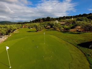 an overhead view of a green golf course at Hacienda Noa in Grohote