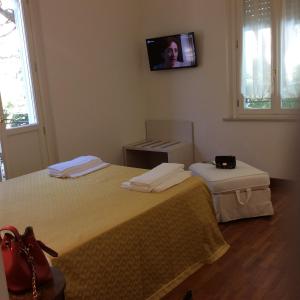 Säng eller sängar i ett rum på Residenza Grand Hotel Riccione