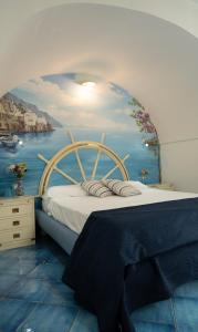 um quarto com uma cama com um quadro na parede em La Rosa dei Venti - Scirocco em Amalfi