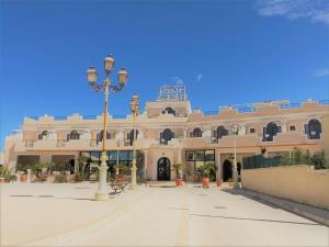 a building with a street light in front of it at Hotel Medusa in Lampedusa