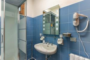 a bathroom with a sink and a mirror at Dario apartment - Magnolia Holidays in Fertilia +19 photos