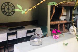 a dining room with two tables and a clock on the wall at Gîte alsacien in Eckwersheim