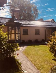 a house with a street light in the yard at Anni in Ventspils