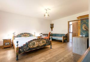 a bedroom with two beds and a mirror at Hotel Edelhof in Tarvisio