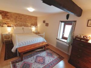 a bedroom with a bed and a window at La Vieille Gorce - Chambres d'Hôtes in the Vienne in Asnois +34 photos