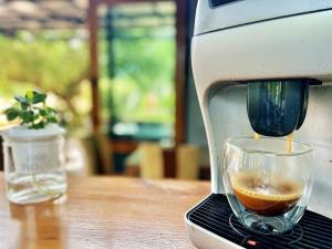 a coffee maker is making a cup of coffee at Family House Zen Boutique Resort in Pai