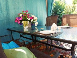 a table with a vase of flowers on it at Guest House Barkhat in Zatoka +40 photos