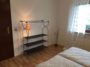 a bedroom with a lamp next to a bed at Fewo Moselblick in Traben-Trarbach