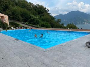 een groot zwembad met mensen in het water bij Casa Bella Vista in San Siro