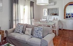 a living room with a couch and a table at 4 Bedroom Gorgeous Home In Frigiliana in Nerja