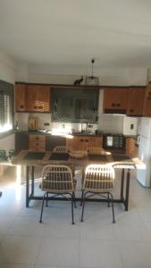 a kitchen with a table and two chairs in it at Chrisambelos Apartments in Istro