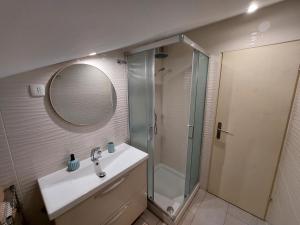 a bathroom with a shower and a sink and a mirror at Apartma Marina in Piran +14 photos