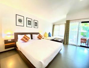 a bedroom with a large bed and a large window at Family House Zen Boutique Resort in Pai