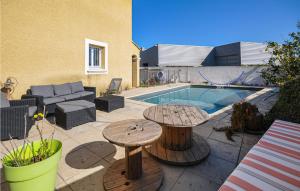 a patio with two tables and a swimming pool at 2 Bedroom Stunning Home In La Farlede in La Farlède
