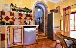 a kitchen with a refrigerator and a table and a dining room at Beautiful Home In Mejannes-Les-Ales in Méjannes-lès-Alès