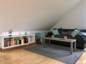 a living room with a couch and a coffee table at Ankerplatz Langballig in Langballig