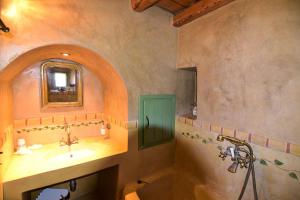 a bathroom with a tub and a sink and a mirror at Axion Studios in Aroniadika