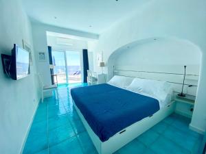 a bedroom with a bed and a television in a room at Casa Sofia Boutique Hotel in Sant'Angelo D'Ischia