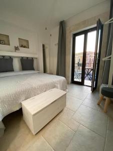 a bedroom with a bed and a large window at Flavì in Bari