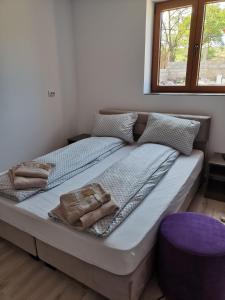a bed with towels on it in a bedroom at CASA BIA CRIBO Sannicolau de Munte - bai termale in Săcueni