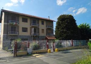 budynek z płotem i żółtym hydrantem pożarowym w obiekcie La Magnolia B&B w mieście Gassino Torinese