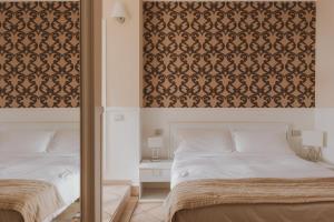 ローマにあるResidenza Il Giglioのベッドルーム1室(ベッド2台、大型ヘッドボード付)