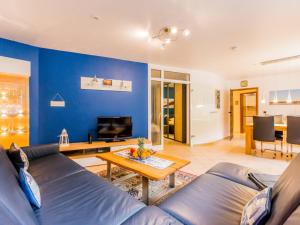 uma sala de estar azul com um sofá e uma mesa em Residenz Meeresbrandung em Cuxhaven