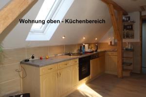 a kitchen with a sink and a skylight at Bauernhaus Questin in Alt Bukow
