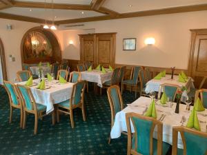 a dining room with tables and chairs with green napkins at Landgasthof zur Post in Mitterdorf im Mürztal