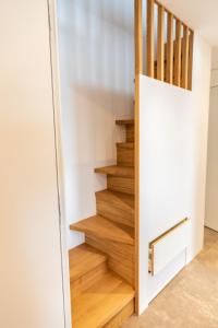 a stairwell with wooden stairs in a house at Bodenseedomizil in Lochau