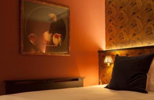 a bedroom with a bed and a painting on the wall at House Belfast Hotel in Belfast