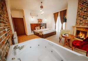 a bathroom with a tub and a living room with a fireplace at Sea House Hotel in Ağva +51 photos