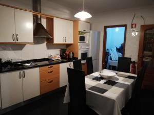 a kitchen with a table and a kitchen with a tableablish at Imaculado Village in Funchal