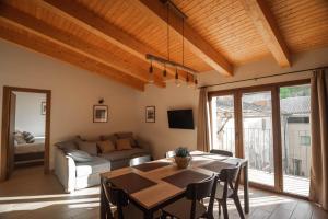a living room with a table and a couch at Cal Negret Rural Apartments in Alós de Balaguer