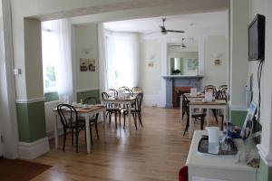 a dining room with wooden tables and chairs at Beamsley Lodge B&B in Eastbourne