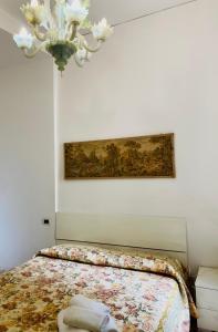 a bedroom with a bed and a painting on the wall at B&B Ca' Dor in Venice