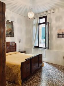 a bedroom with a large bed and a window at B&B Ca' Dor in Venice