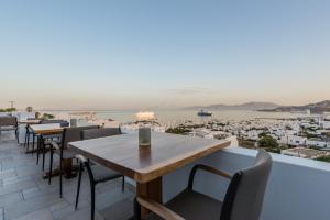 a table and chairs on a balcony with a view at Ibiscus Boutique in Mikonos